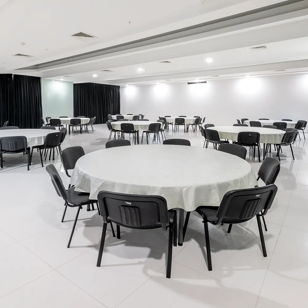 Event room at Alvor Baía Resort Hotel set with round tables and chairs for events.