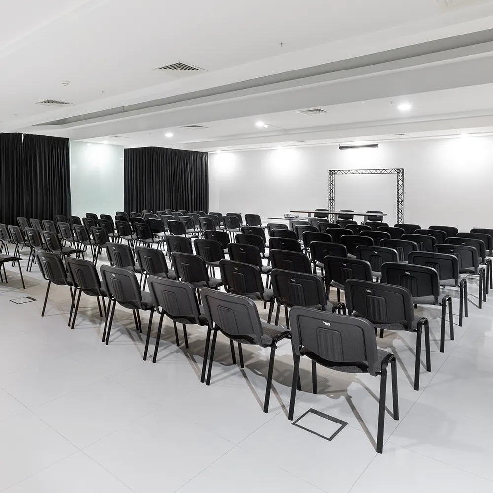 Event room at Alvor Baía Resort Hotel arranged in theatre style with rows of chairs and space for presentations.