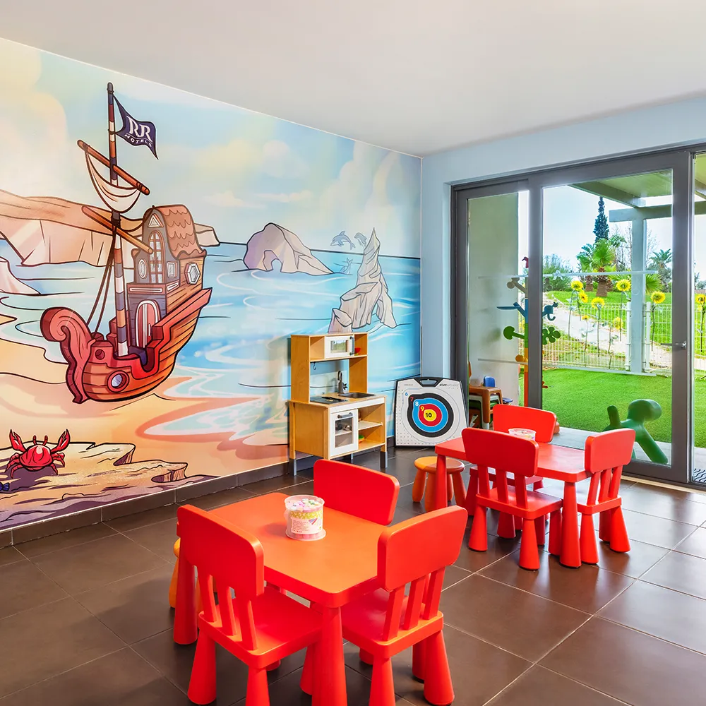 Kids Club at Alvor Baía Resort Hotel with children's tables, games and pirate-themed décor.