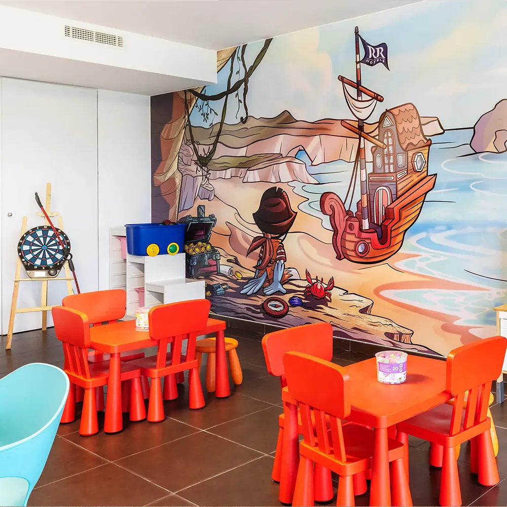 Indoor Kids Club area at Alvor Baía Resort Hotel with children's tables, toys and pirate-themed décor.