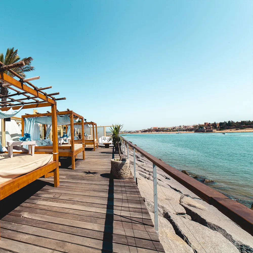 Balinese daybeds beside the wooden deck at NoSoloÁgua Beach Club.