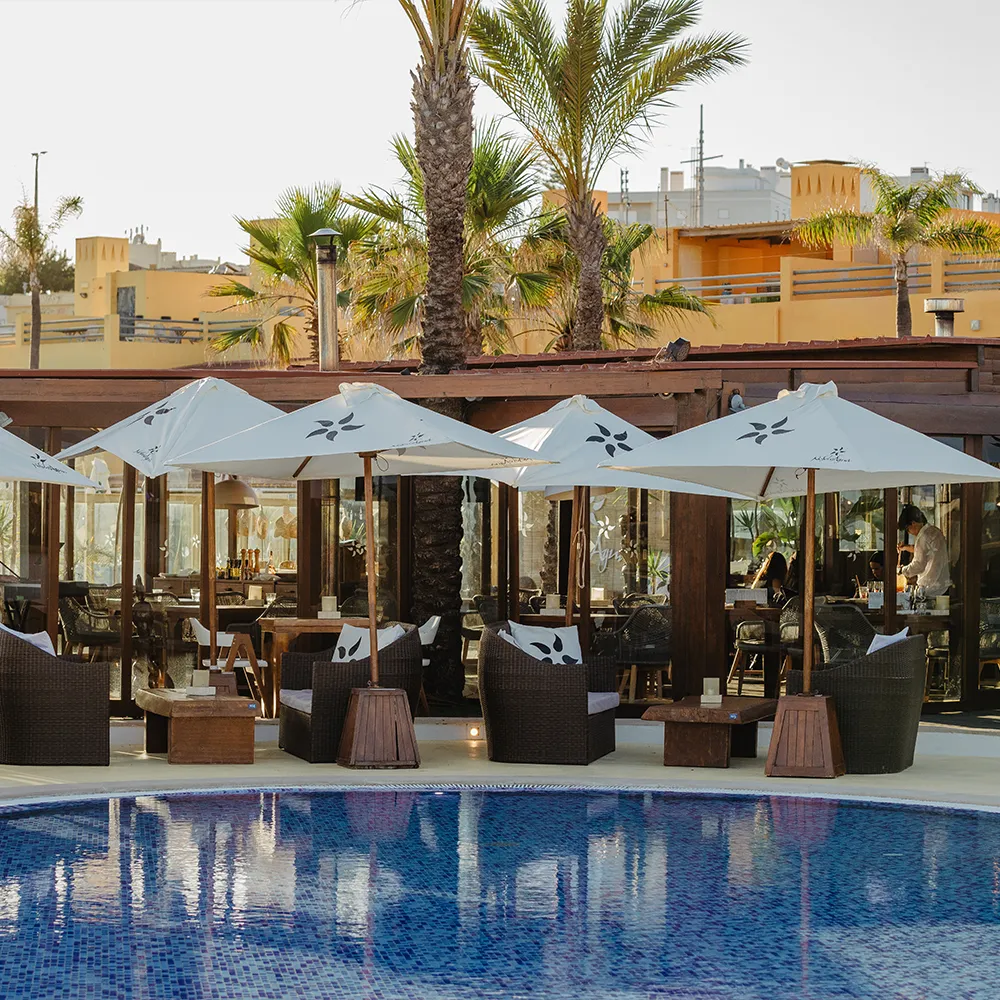 Restaurant terrace overlooking the swimming pool at NoSoloÁgua Beach Club.
